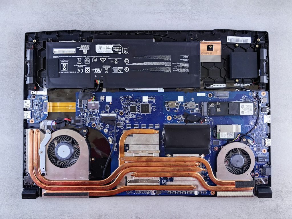 Inside a Windows laptop showing the motherboard, fans and battery
