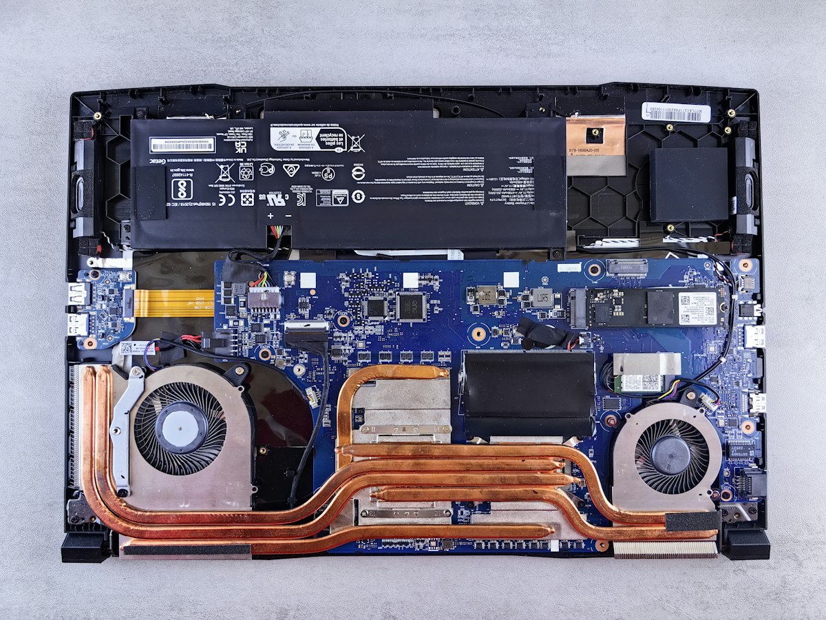 Inside a Windows laptop showing the motherboard, fans and battery